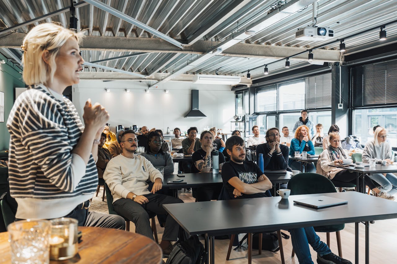 gallery-4 A dynamic speaker engaging a diverse audience in a modern workshop setting.